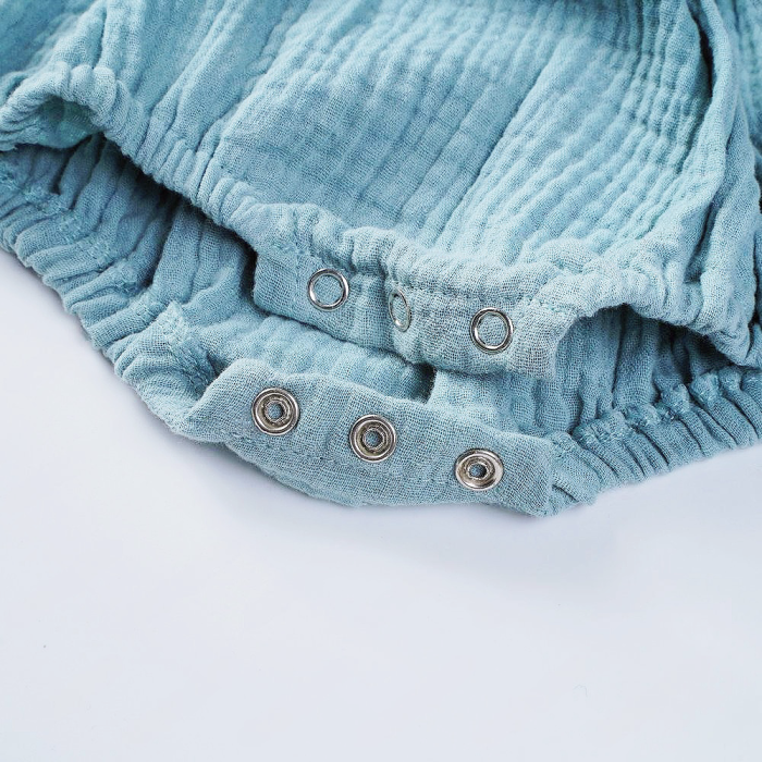 Three buttons on the crotch of a baby crawl suit